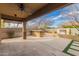 Outdoor patio area offering a tranquil outdoor retreat with a built-in grill, a waterfall and lush landscaping at 412 W Lyle Ave, San Tan Valley, AZ 85140