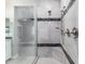 Luxurious walk-in shower with marble style tiling, modern shower fixtures, and glass door at 412 W Lyle Ave, San Tan Valley, AZ 85140