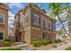 Inviting townhome featuring stacked stone accents, muted green siding, and professional landscaping at 453 N Alder Ct, Gilbert, AZ 85233