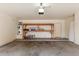 Spacious garage with water heater, wooden shelving and concrete floors at 453 N Alder Ct, Gilbert, AZ 85233