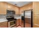 Well-lit kitchen features stainless appliances, mosaic backsplash and light wood cabinets at 453 N Alder Ct, Gilbert, AZ 85233