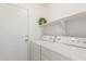 Bright laundry room with wreath and folding shelf above the washer/dryer units at 453 N Alder Ct, Gilbert, AZ 85233