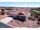 Aerial view of home with desert landscaping, solar panels and three car garage at 4846 S Rimrock Loop, Gold Canyon, AZ 85118