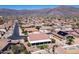 A high angle shows a desert neighborhood and property featuring mature landscaping and a patio at 4846 S Rimrock Loop, Gold Canyon, AZ 85118