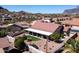 Aerial view showcases backyard with desert landscape and patio in a desert community at 4846 S Rimrock Loop, Gold Canyon, AZ 85118