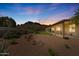 Private backyard oasis featuring desert landscaping, covered patio, and stunning mountain views at 4846 S Rimrock Loop, Gold Canyon, AZ 85118