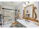 Bathroom with a decorative mirror, modern vanity, and glass-enclosed shower and tub combination at 4846 S Rimrock Loop, Gold Canyon, AZ 85118