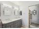 Bathroom featuring a double vanity with gray cabinets, tile flooring, and a walk-in shower at 4846 S Rimrock Loop, Gold Canyon, AZ 85118