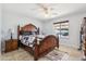 Cozy bedroom featuring tile flooring, a ceiling fan, and a view of the outdoors from the window at 4846 S Rimrock Loop, Gold Canyon, AZ 85118