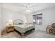 Bright bedroom featuring neutral walls, tile floors, a ceiling fan, and natural light from a window at 4846 S Rimrock Loop, Gold Canyon, AZ 85118