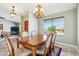 Elegant dining room featuring a wooden table, classic chandelier, and a view to the street at 4846 S Rimrock Loop, Gold Canyon, AZ 85118