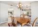 Open concept dining room showcasing elegant chandelier and seamless flow to living spaces at 4846 S Rimrock Loop, Gold Canyon, AZ 85118