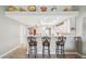 Well-lit kitchen with bar seating, white cabinets, and decorative shelves at 4846 S Rimrock Loop, Gold Canyon, AZ 85118