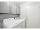 Laundry room featuring side-by-side washer and dryer with upper cabinets for added storage at 4846 S Rimrock Loop, Gold Canyon, AZ 85118