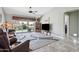 Bright living room with sliding glass doors to patio, ceiling fan, and decorative area rug at 4846 S Rimrock Loop, Gold Canyon, AZ 85118