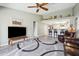 Relaxing living room with open access to a kitchen, ceiling fan, and decorative area rug at 4846 S Rimrock Loop, Gold Canyon, AZ 85118