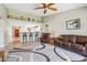 Comfortable living room with leather seating, a ceiling fan, and an open view to the kitchen at 4846 S Rimrock Loop, Gold Canyon, AZ 85118