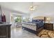 Inviting bedroom with large bay window, tiled floor, ceiling fan, and tufted headboard at 4846 S Rimrock Loop, Gold Canyon, AZ 85118