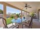 Inviting outdoor patio with ceiling fan and large glass-top dining table with seating at 4846 S Rimrock Loop, Gold Canyon, AZ 85118