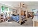 Bedroom with a four-poster bed, ceiling fan and a window with green views at 4913 E Halifax St, Mesa, AZ 85205