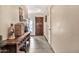 Hallway featuring neutral walls, tiled floors, a wooden door, and storage solutions at 4913 E Halifax St, Mesa, AZ 85205