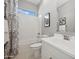 Well-lit bathroom featuring a modern vanity, subway tile shower, and stylish rose-patterned shower curtain at 505 E Aurora Dr, San Tan Valley, AZ 85140