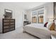 Bright bedroom with a large window, dresser, and sliding closet door, providing a comfortable and organized space at 505 E Aurora Dr, San Tan Valley, AZ 85140