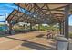 A spacious covered pavilion provides shade and seating for gatherings with picnic tables in a well-maintained community park at 5431 S Canyon Rim --, Mesa, AZ 85212