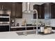 Close up of the kitchen island featuring stainless steel faucet, quartz counter tops, and plenty of storage at 5431 S Canyon Rim --, Mesa, AZ 85212