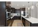 Spacious kitchen featuring stainless steel appliances, dark cabinetry, and a large center island with quartz countertops at 5431 S Canyon Rim --, Mesa, AZ 85212