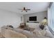 Comfortable living room featuring a large sectional sofa, a ceiling fan, and contemporary decor at 5431 S Canyon Rim --, Mesa, AZ 85212