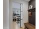 Hallway peek into a bright home office space with a large window, shelving and a sliding glass door at 5431 S Canyon Rim --, Mesa, AZ 85212