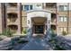 Building entrance with stone pillars, manicured landscape, and covered entry at 5450 E Deer Valley Dr # 3008, Phoenix, AZ 85054