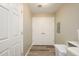 Hallway with wood-look floors leads to a pair of white paneled doors and utility closet at 5450 E Deer Valley Dr # 3008, Phoenix, AZ 85054