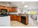 Well-lit kitchen featuring tile floors, granite counters, a gas range, and black appliances at 5450 E Deer Valley Dr # 3008, Phoenix, AZ 85054