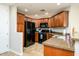 Well-lit kitchen featuring tile floors, granite counters, a gas range, and black appliances at 5450 E Deer Valley Dr # 3008, Phoenix, AZ 85054