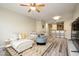 Bright and airy living room featuring wood floors, neutral walls, a ceiling fan, and stylish furniture at 5450 E Deer Valley Dr # 3008, Phoenix, AZ 85054