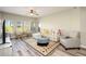 Bright and airy living room featuring wood floors, neutral walls, a ceiling fan, and stylish furniture at 5450 E Deer Valley Dr # 3008, Phoenix, AZ 85054