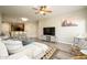 Bright and airy living room featuring wood floors, neutral walls, a ceiling fan, and stylish furniture at 5450 E Deer Valley Dr # 3008, Phoenix, AZ 85054