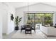 Bright dining area with a modern table and chairs, opening to a beautifully landscaped outdoor living space at 551 E Aurora Dr, San Tan Valley, AZ 85140