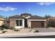 Charming single-story home with a brick accent wall, desert landscaping, and a modern-style garage door at 551 E Aurora Dr, San Tan Valley, AZ 85140