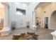 Grand foyer with wood tile flooring, high ceilings, white columns and art pieces at 6132 E Yucca St, Scottsdale, AZ 85254