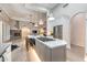 Open concept kitchen features an island cooktop and view of the fireplace and living area at 6132 E Yucca St, Scottsdale, AZ 85254