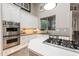 Modern kitchen with stainless steel ovens, a gas cooktop, and a garden window at 6132 E Yucca St, Scottsdale, AZ 85254