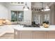 Kitchen island detail with built-in cooktop, sink, and view to seating area at 6132 E Yucca St, Scottsdale, AZ 85254