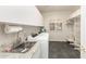 Well-organized laundry room with granite countertops, washer, dryer, and ample shelving at 6132 E Yucca St, Scottsdale, AZ 85254