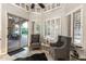 Bright living room featuring plantation shutters, comfortable seating, and access to outdoor living space at 6132 E Yucca St, Scottsdale, AZ 85254