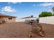 Large backyard area with gravel and a boat on a trailer, complemented by brick decor at 641 N 61St Pl, Mesa, AZ 85205