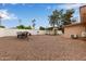 Expansive backyard with gravel landscaping, a covered boat and an attractive gazebo for outdoor enjoyment at 641 N 61St Pl, Mesa, AZ 85205