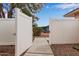 View of an open backyard gate to the yard with gravel, patio and seating area visible in the background at 641 N 61St Pl, Mesa, AZ 85205